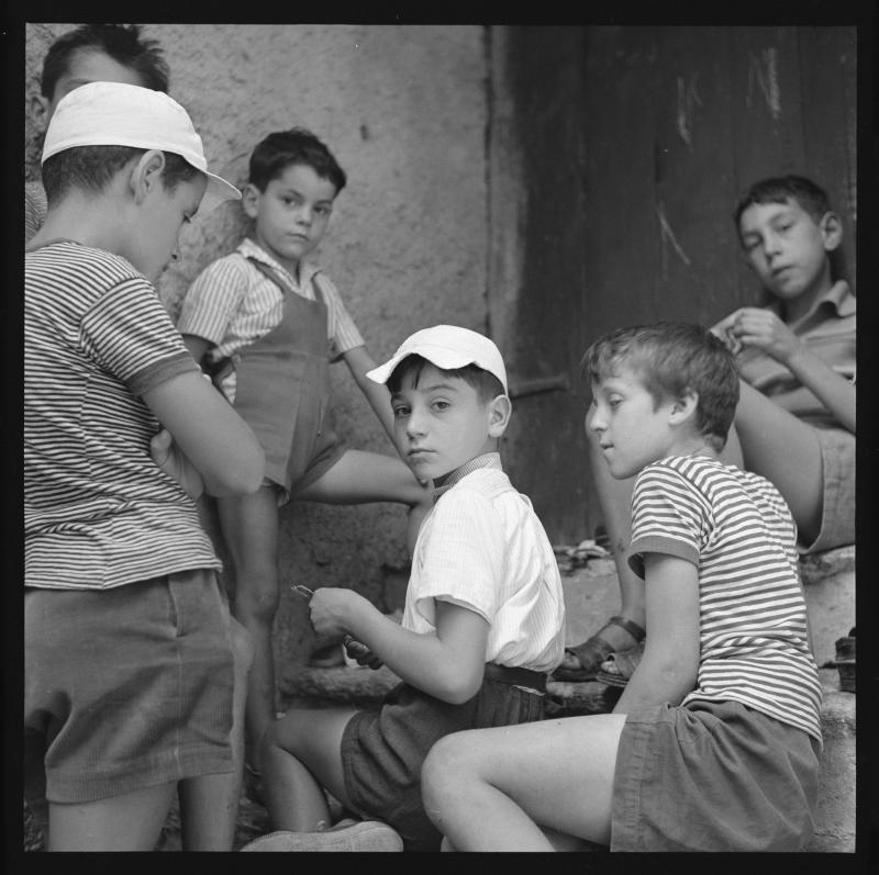 Photograph of kids sitting on stoop.