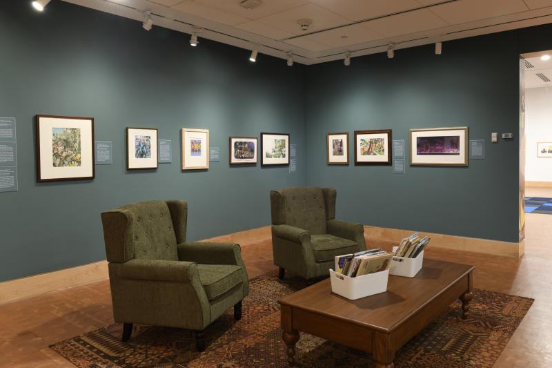 Photograph of gallery showing framed art and graphics.