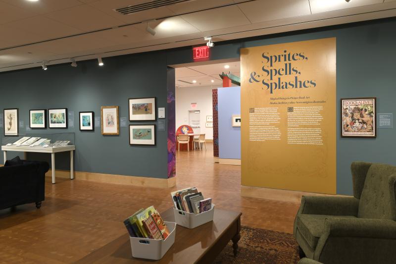 Photograph of gallery showing framed art and graphics.