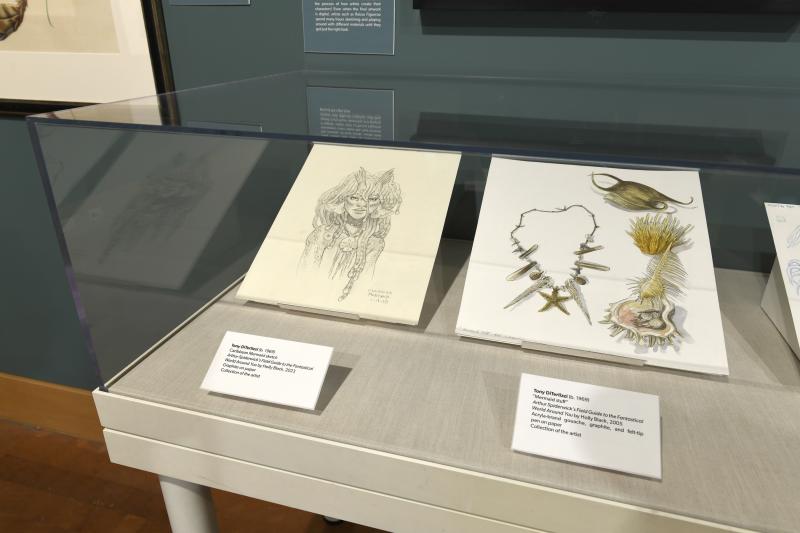 Photograph of gallery showing framed art and graphics.