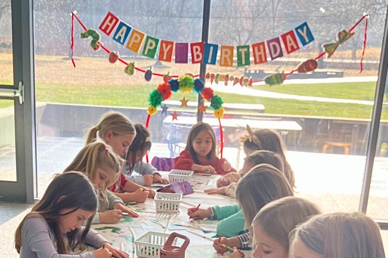 Birthday party table with children drawing.