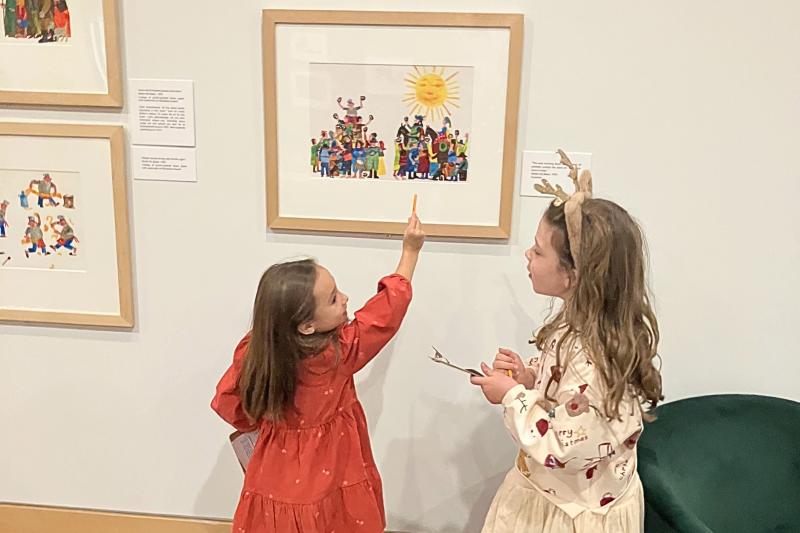 Two children in the gallery doing a scavenger hunt.