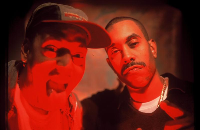 Photograph of two men in red light.