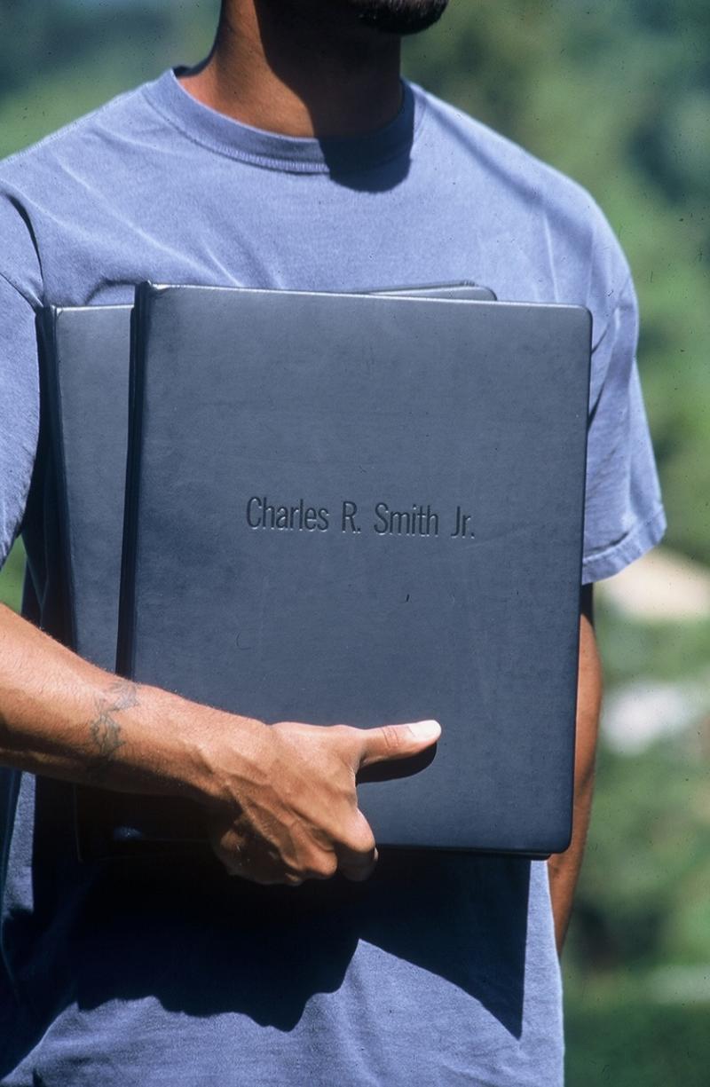 Image of man holding portfolio