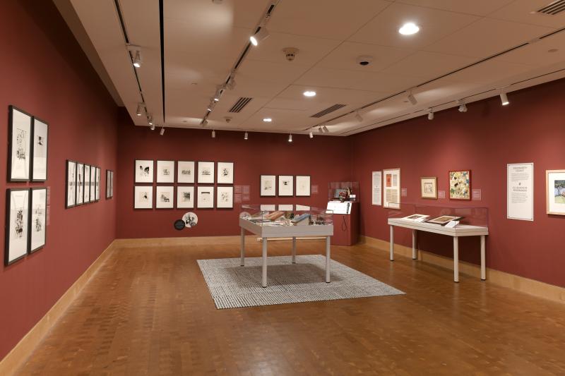 Photograph of gallery showing framed art and graphics.