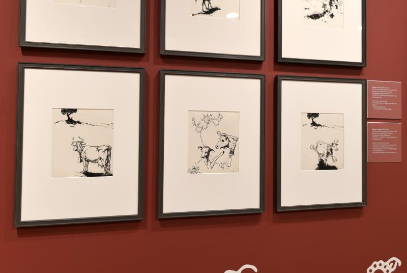 Photograph of gallery showing framed art and graphics.
