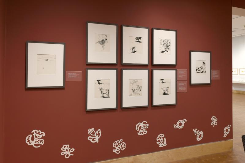 Photograph of gallery showing framed art and graphics.