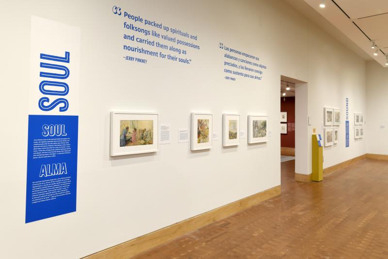 Photograph of gallery showing framed art and graphics.