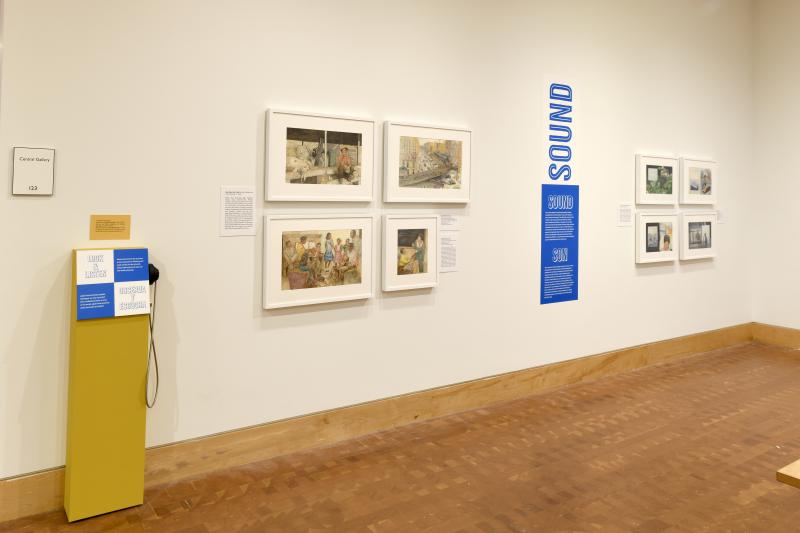 Photograph of gallery showing framed art and graphics.