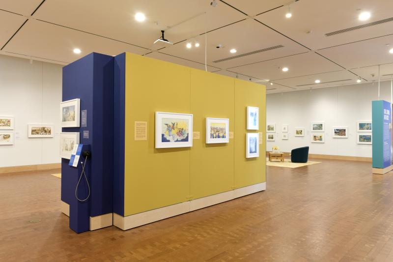 Photograph of gallery showing framed art and graphics.