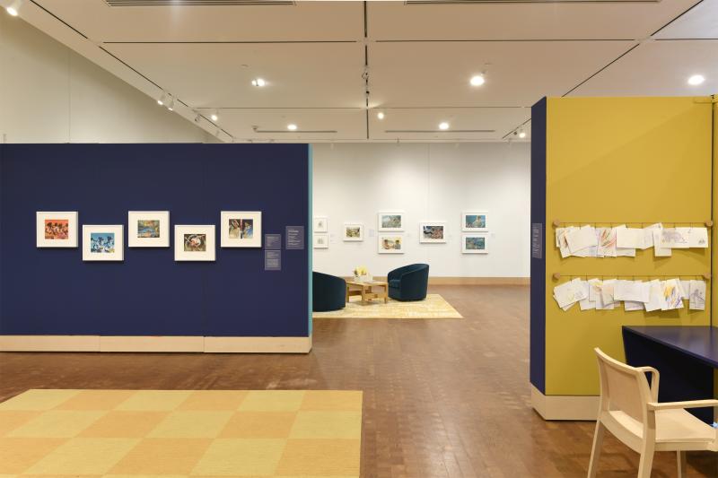 Photograph of gallery showing framed art and graphics.