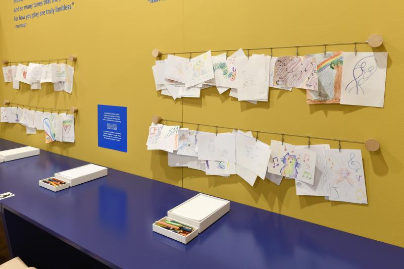 Photograph of gallery showing framed art and graphics.