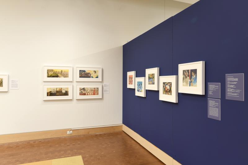 Photograph of gallery showing framed art and graphics.