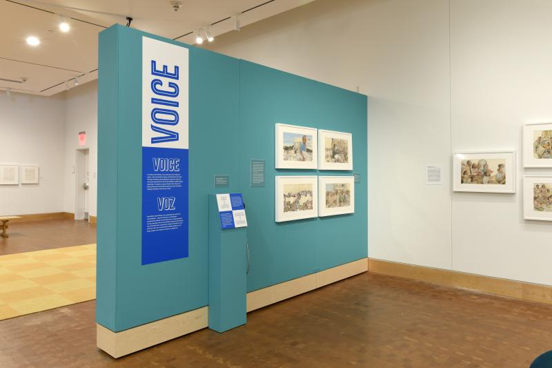 Photograph of gallery showing framed art and graphics.