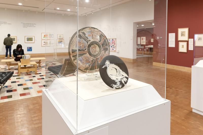 Photograph of gallery showing framed art and graphics.