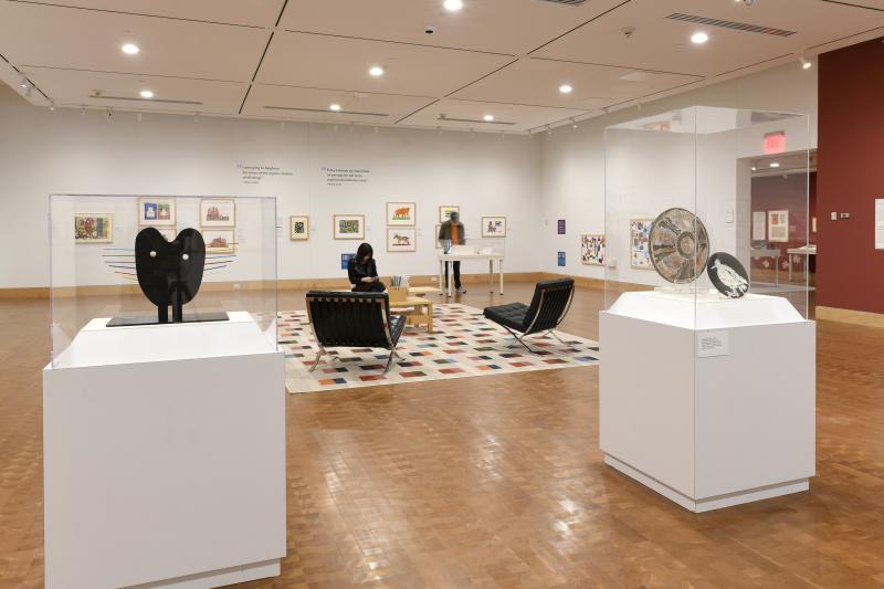 Photograph of gallery showing framed art and graphics.
