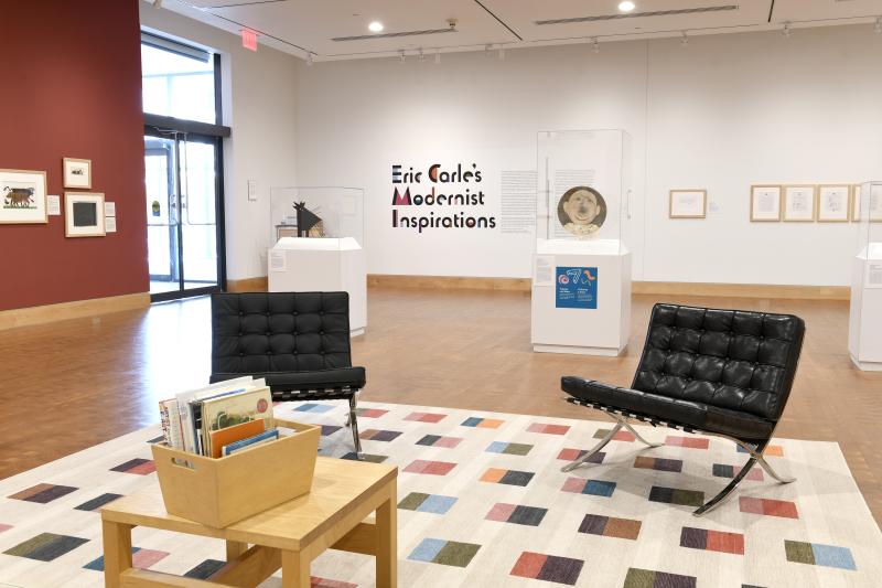 Photograph of gallery showing framed art and graphics.