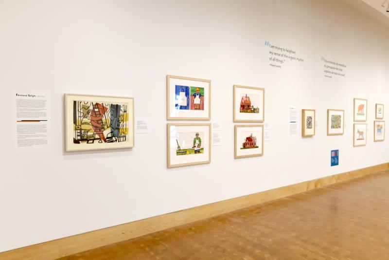 Photograph of gallery showing framed art and graphics.