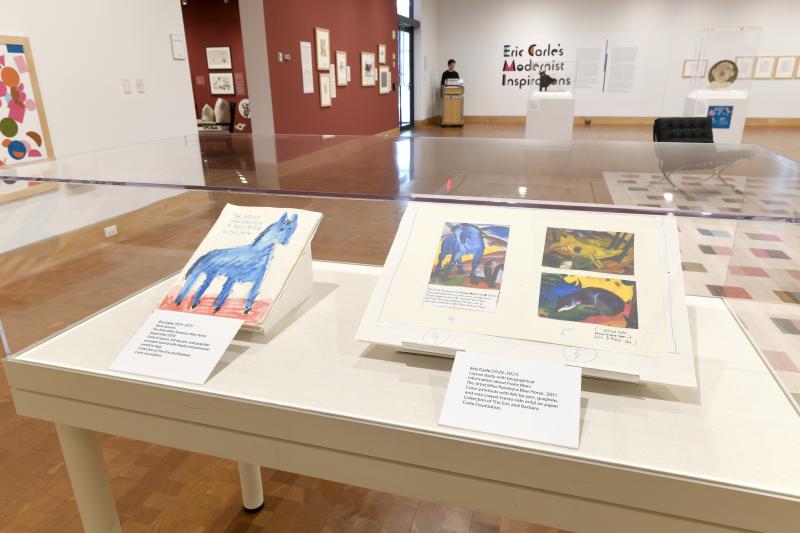 Photograph of gallery showing framed art and graphics.