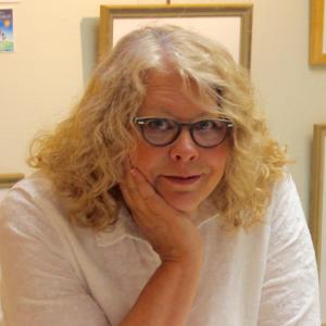 a woman with blonde hair wearing a white shirt