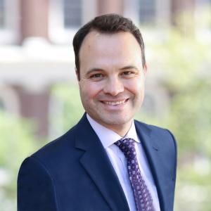 Caucasian man in a business suit, smiling