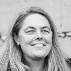 woman in a dark coat, smiling
