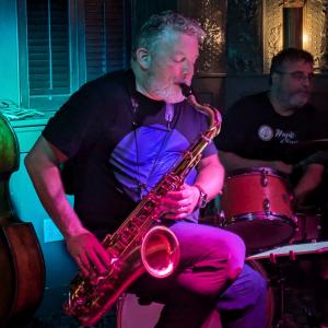 Dr. Ed Orgill of the Wolf Pit Collective playing the saxophone.
