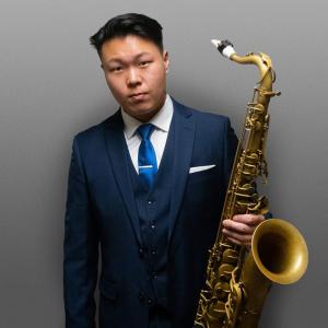 Ben Malynoski holding saxophone. 