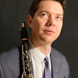 EvanArntzen holding a clarinet and looking up. 