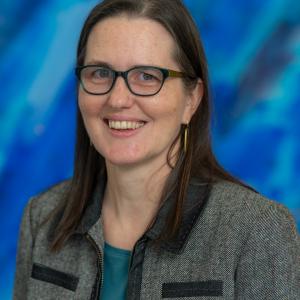 woman with brown hair and glasses