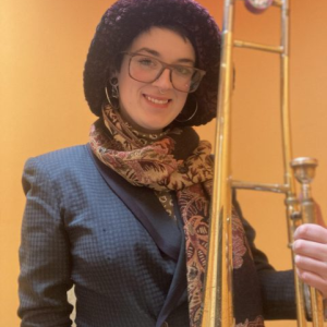 Woman holding a trombone.