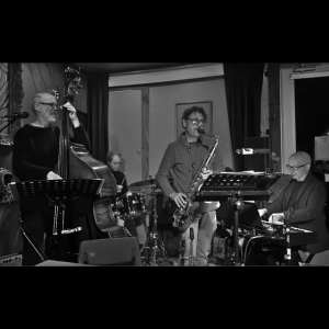 Three musicians performing on stage.