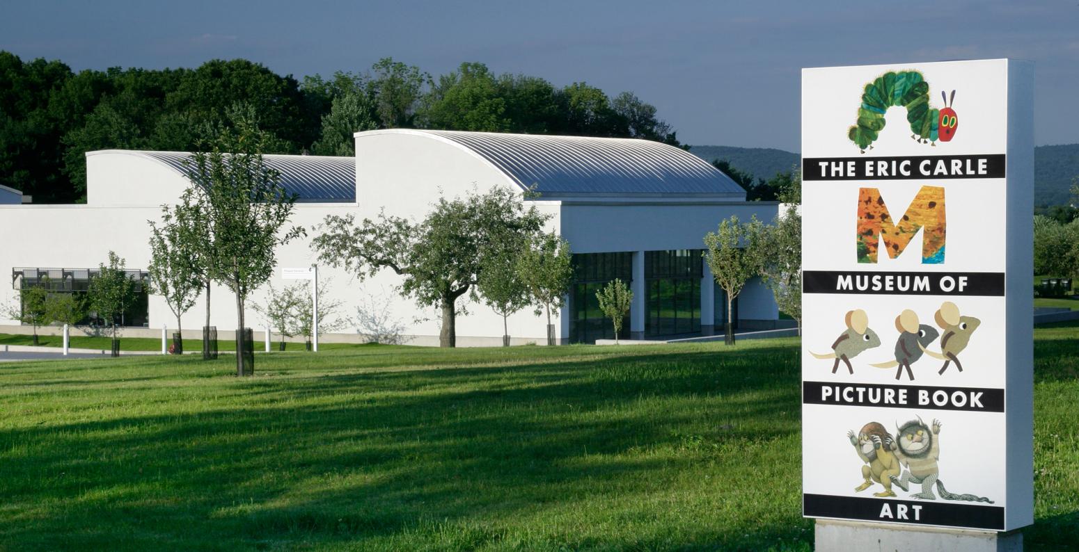 A photograph of The Eric Carle Museum of Picture Book Art with its sign in the front. 