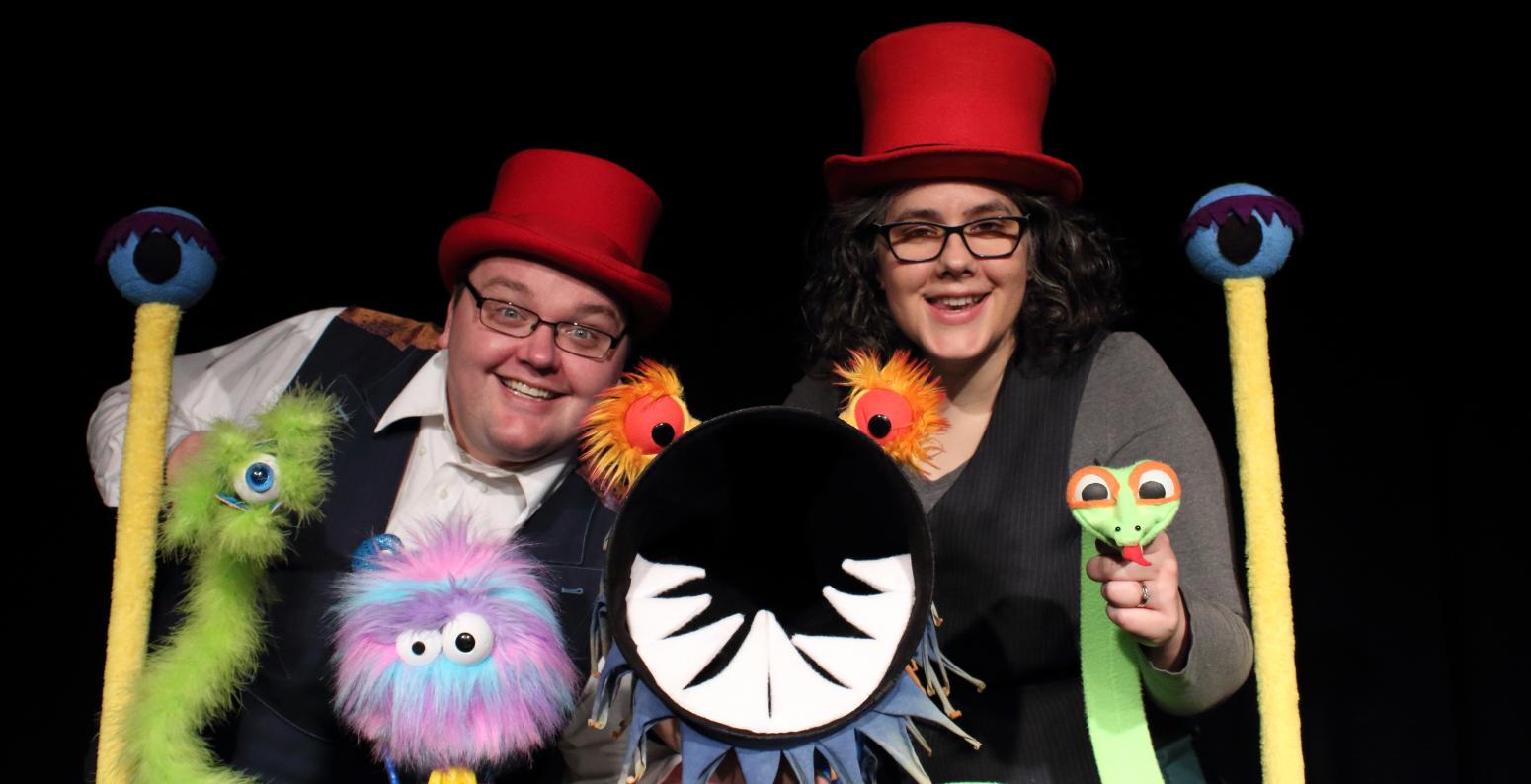 Photo of CactusHead Puppets puppeteers smiling and holding four puppets.