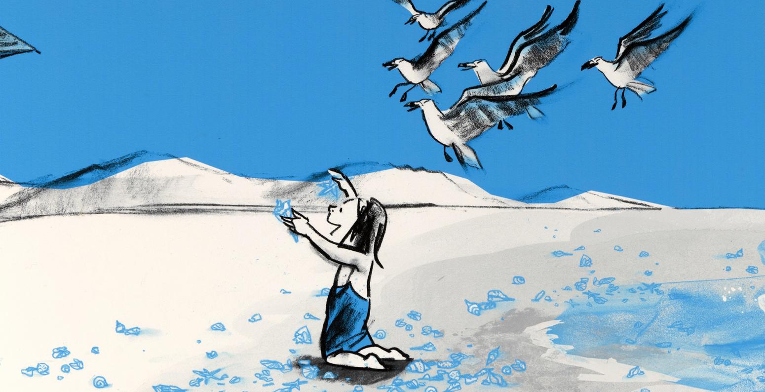 Child playing on seashore with seagulls flying overhead.