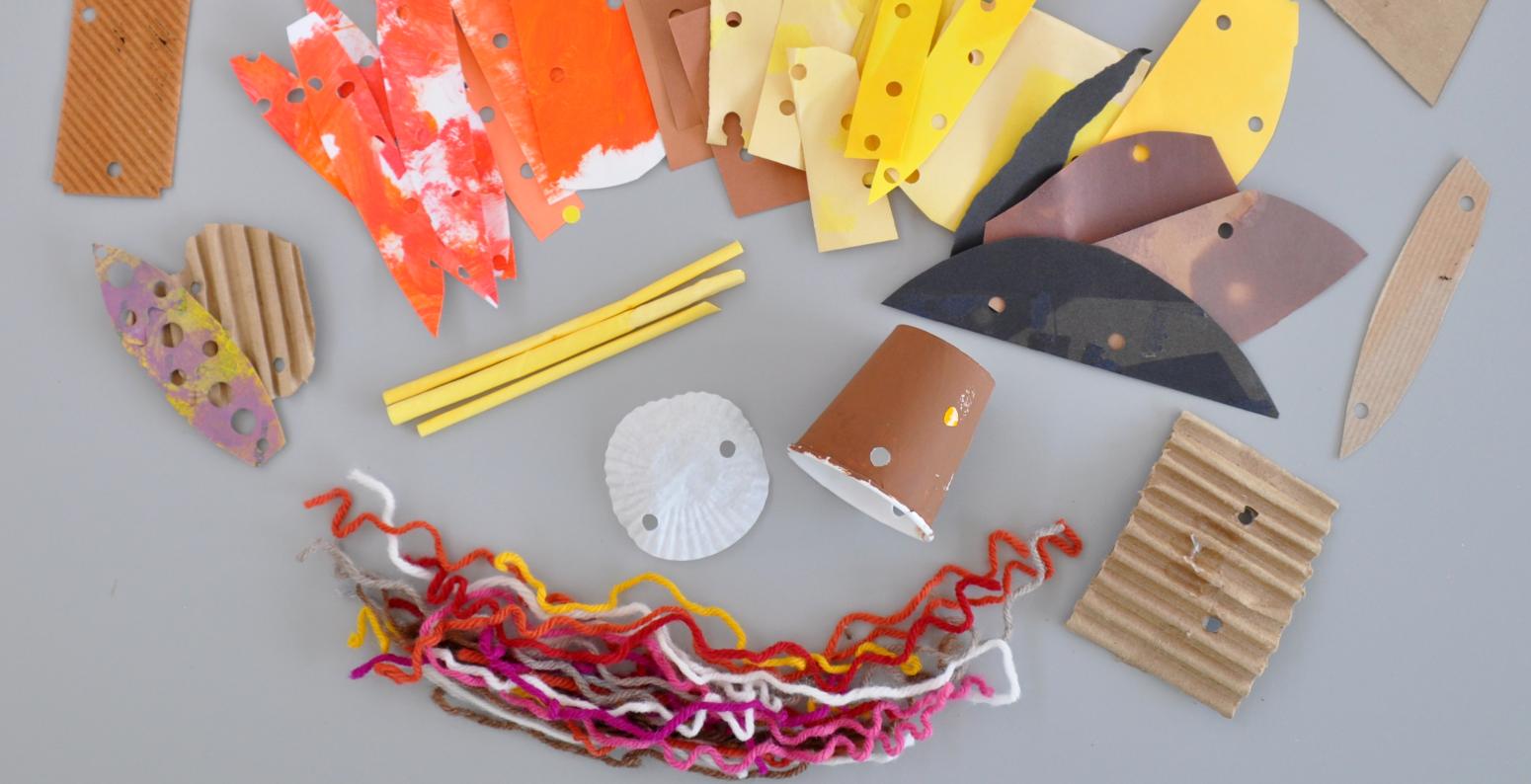 An array of cardboard, paper materials, and yarns.