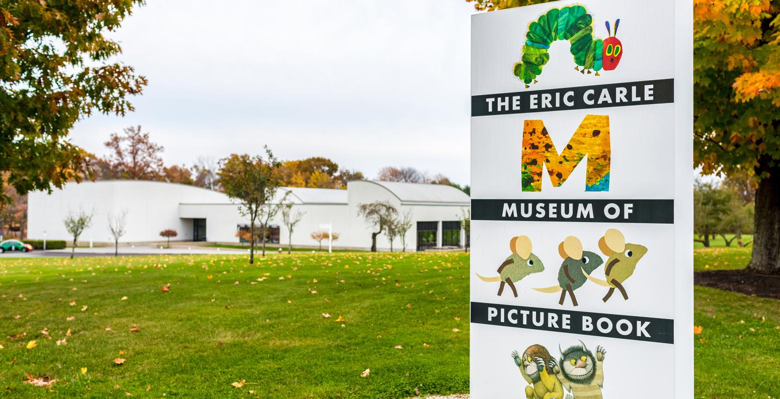The Eric Carle Museum of Picture Book Art entrance sign with Museum building in the background