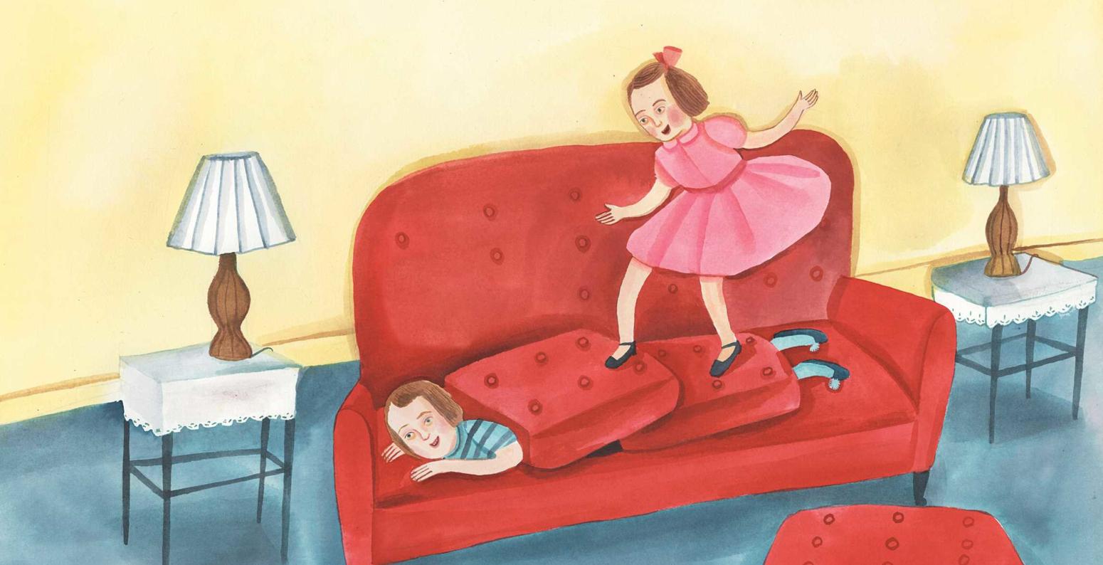 A young Temple Grandin under red sofa covers as her little sister hops on top of the cushions.