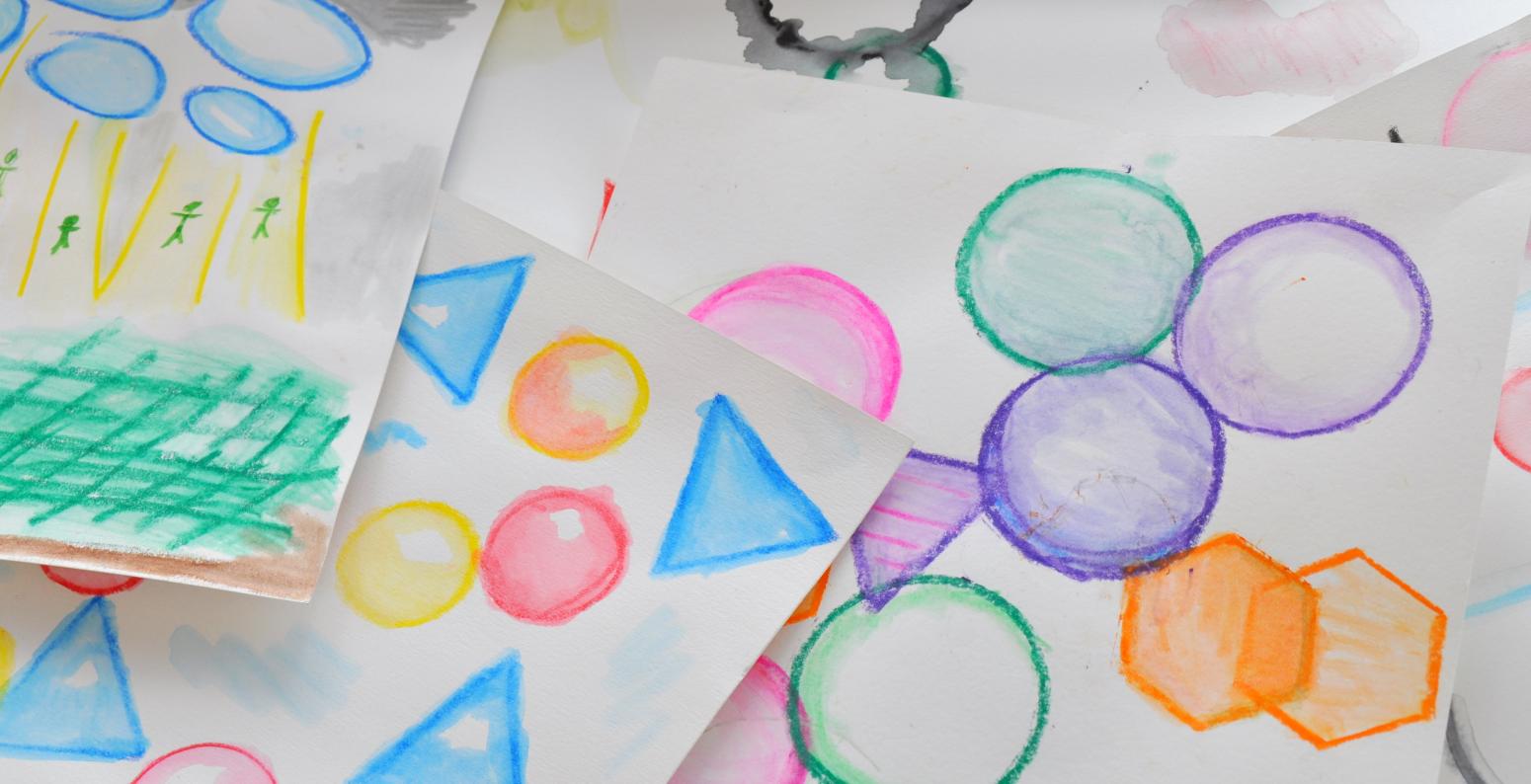 Colorful painted shapes made using watercolor pencils.