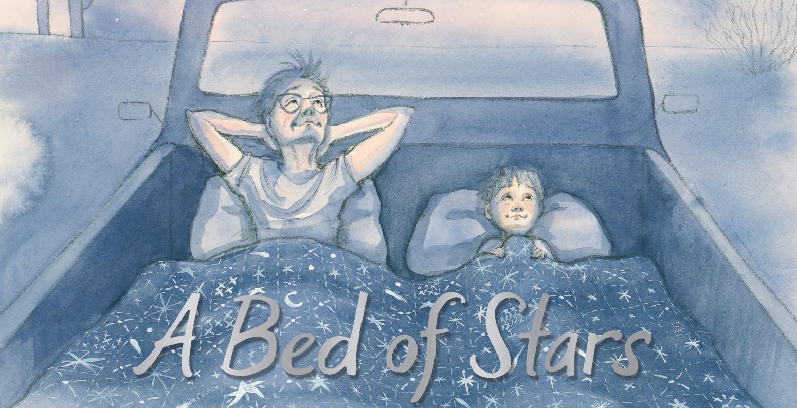 A father and child lie down on the back of a pickup truck, looking up at the stars.