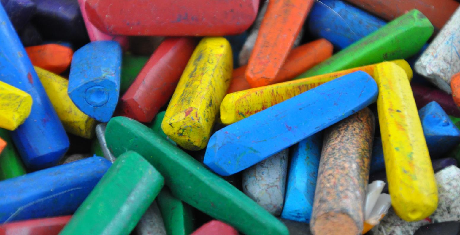 A colorful pile of small, used crayons.
