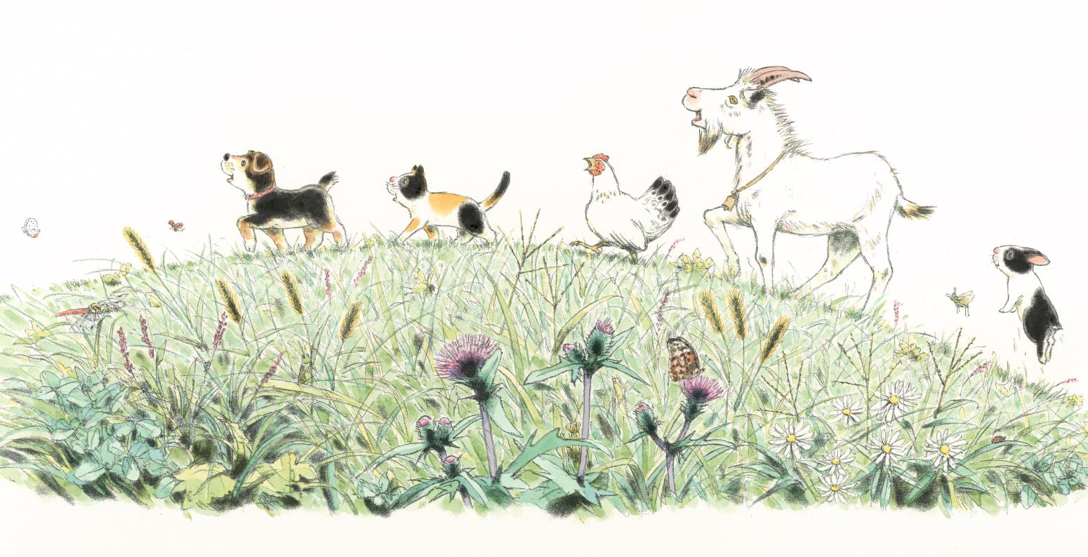 Animals walk across a mound of grass.