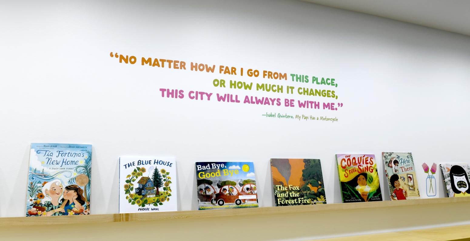 Photograph of books on shelf with quote above.