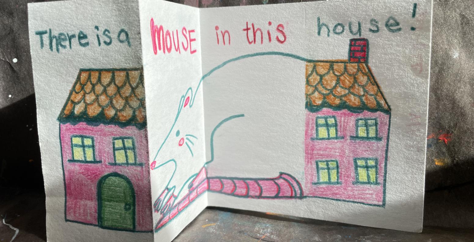 A folded paper with a drawing of a house, revealing a drawing of a mouse in the fold.