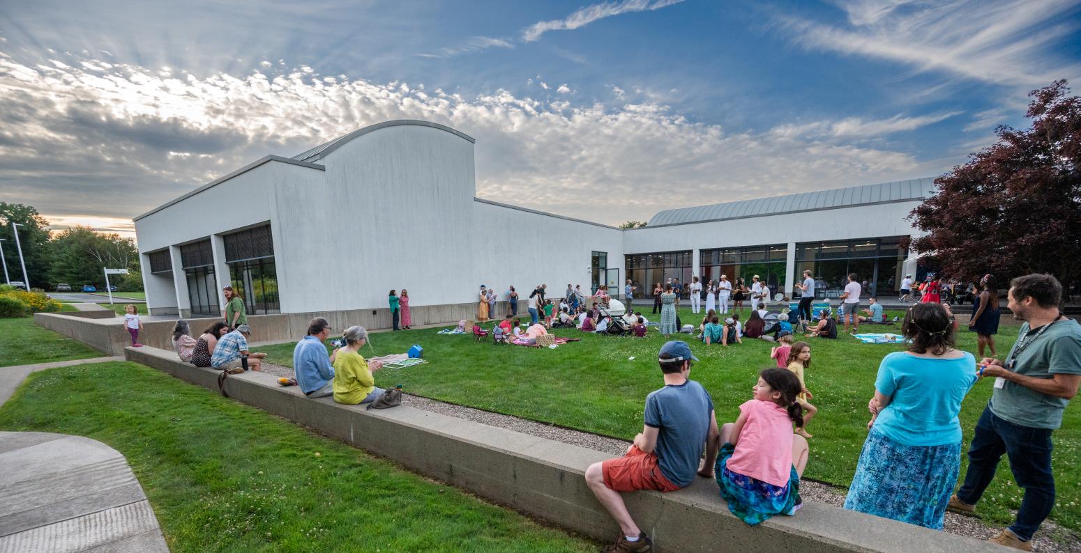 Guests in the courtyard enjoying music during Summer Nights evening.