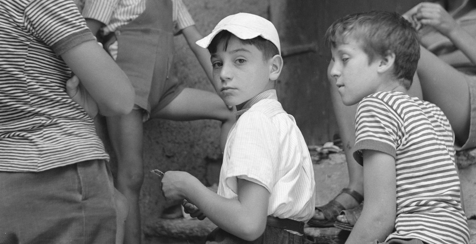 Photograph of kids sitting on stoop. 