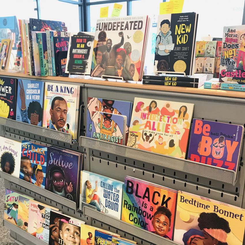 Bookstore shelves showing a display of colorful picture books by Black authors and illustrators.
