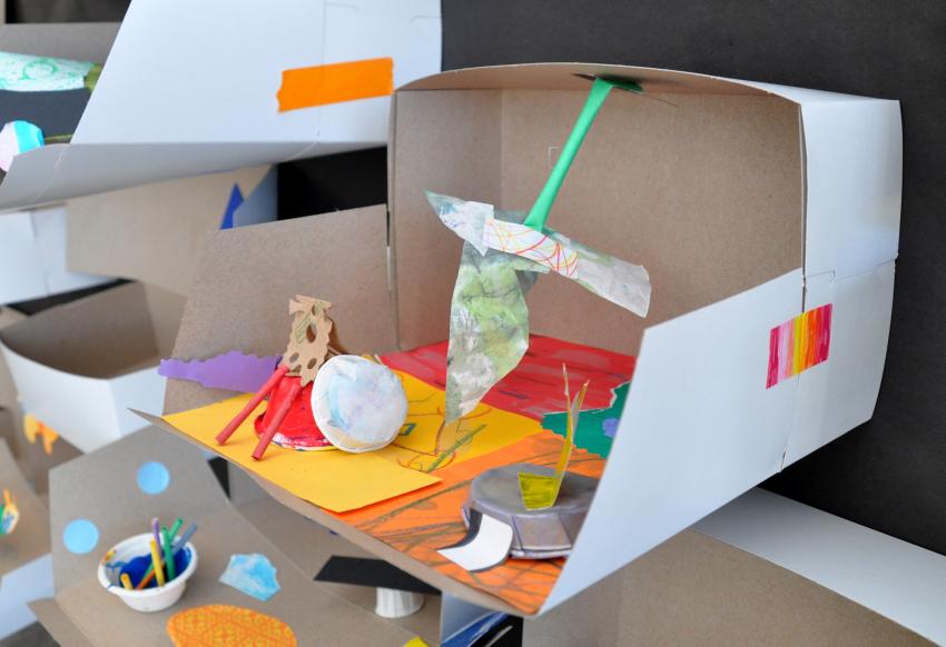 Cardboard box diorama with paper sculptures inside
