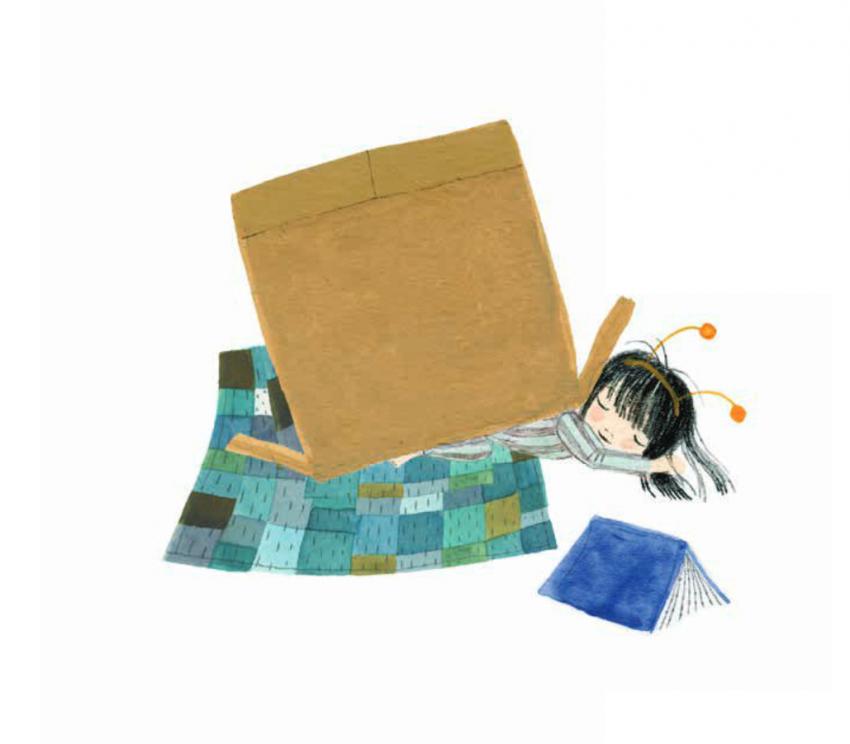 A sleeping girl lies on a quilt wearing a snail antennae headband with a simple cardboard box on back like a snail shell.