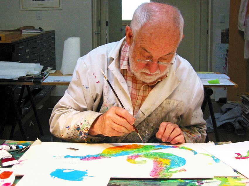Eric Carle sitting at table painting seahorses